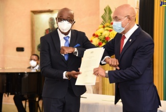 Governor-General, His Excellency, the Most Hon. Sir Patrick Allen (right), presents Instruments of Office to new Custos of St. Andrew, Hon. Ian Forbes, at an installation ceremony held at King’s House today (January 31).

