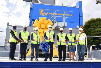 Prime Minister, the Most Hon. Andrew Holness (centre), cuts the ribbon to unveil Kingston Wharves Limited’s (KWL) US$60-million investment in logistics and port development, at Port Bustamante on Wednesday (January 12). Joining the Prime Minister (from left) are Chief Executive Officer of KWL, Mark Williams; President and Chief Executive Officer of the Port Authority of Jamaica, Professor Gordon Shirley; Deputy Chairman of KWL, Grantley Stephenson; Chairman of KWL, Jeffrey Hall; Group Chief Financial Officer, Clover Moodie; and President of Shoreline Foundation, James Roya.