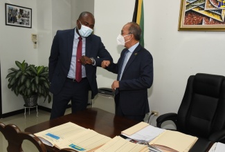 Deputy Prime Minister and Minister of National Security, Hon. Dr. Horace Chang (right), greets newly appointed Minister of State, Hon. Zavia Mayne, on his arrival at the Ministry’s offices in New Kingston for the first day of work on Tuesday (January 11).