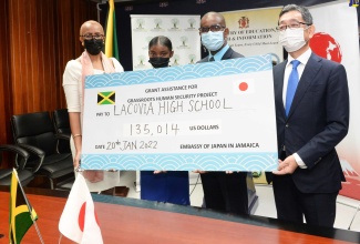 Minister of Education and Youth,  Hon. Fayval Williams; Head Girl of Lacovia High School, Tobi-Kay Lyn; Principal of Lacovia High School, Ricardo Bennett and  Ambassador of Japan to Jamaica, His Excellency Masaya Fujiwara, display  a symbolic cheque representing the grant approved by the Government of Japan to purchase two school buses for Lacovia High School. The official signing ceremony was held at the Ministry's headquarters in Kingston, today (January 20). 