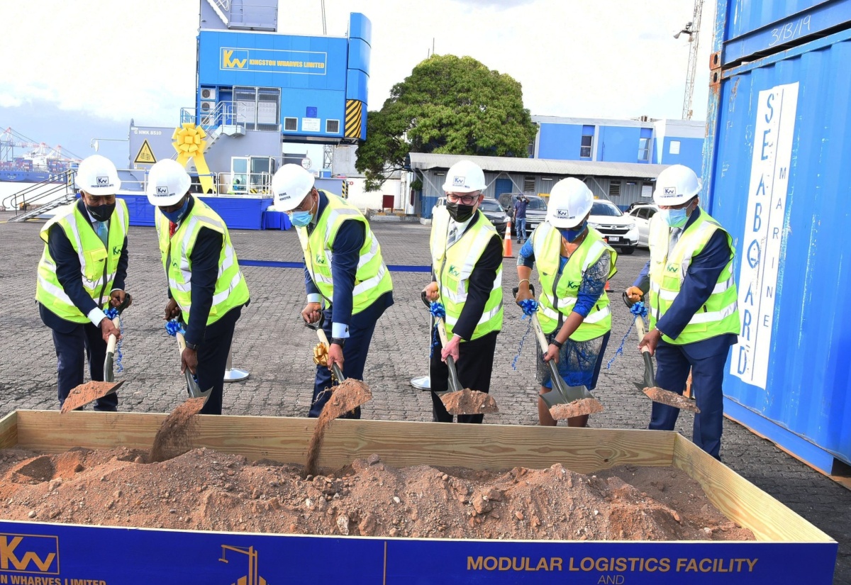 Prime Minister, the Most Hon. Andrew Holness (third left), breaks ground at the unveiling of the Kingston Wharves Limited (KWL) US$60-million investment in logistics and port development, at Port Bustamante, on Wednesday (January 12). Sharing in the occasion (from left) are President and Chief Executive Officer of the Port Authority of Jamaica (PAJ), Professor Gordon Shirley; Chief Executive Officer for KWL, Mark Williams; Chairman of the company, Jeffrey Hall; Group Financial Officer, Clover Moodie, and Deputy Chairman of KWL, Grantley Stephenson.