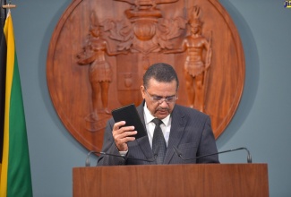 Newly appointed Attorney General, Dr. Derrick McKoy, takes the Oath of Office and Oath of Allegiance during a virtual swearing-in ceremony, on Tuesday (January 11).