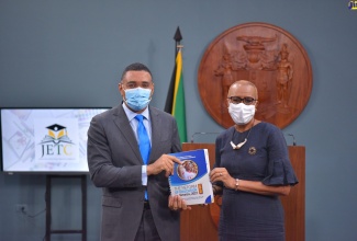 Prime Minister, the Most Hon. Andrew Holness (left), and Minister of Education and Youth, the Hon. Fayval Williams, display the ‘The Reform of Education in Jamaica 2021 Report’ at the virtual launch on Thursday (January 13). Developed by the Jamaica Education Transformation Commission (JETC), the report is a blueprint for the establishment of a  comprehensive strategy to improve student performance and educational productivity across the sector.