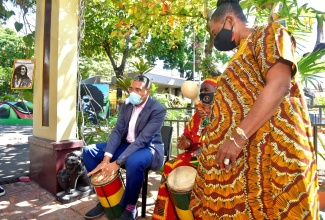 Prime Minister the Most Hon. Andrew Holness (left), plays drums with percussionist Bongo Herman (centre), while Minister of Culture, Gender, Entertainment and Sport, Hon. Olivia Grange (right), plays the shaker. Occasion was the recent Rita Marley: Mystic of a Queen Exhibition, held at the Bob Marley Museum in St. Andrew.  