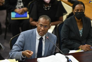 Minister of Finance and the Public Service, Dr. the Hon. Nigel Clarke, speaking during Tuesday’s (March 1) meeting of the Standing Finance Committee of the House of Representatives, which is deliberating the 2022/23 Estimates of Expenditure. Beside him is State Minister in the Ministry, Hon. Marsha Smith.