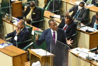 Minister of Finance and the Public Service, Dr. the Hon. Nigel Clarke, opens the 2022/23 Budget Debate in the House of Representatives on Tuesday (March 8). To his right is Deputy Prime Minister and Minister of National Security, Hon. Dr. Horace Chang.