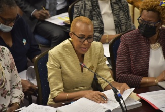 Minister of Education and Youth,  Hon. Fayval Williams (left), speaks at the meeting of the Standing Finance Committee in the House of Representatives on March 3. The members were deliberating the 2022/23 Estimates of Expenditure.  With her is Permanent Secretary in the Ministry, Maureen Dwyer (right). 