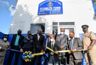 Deputy Prime Minister and Minister of National Security, Hon. Dr. Horace Chang (front, centre),  cuts the ribbon to reopen the refurbished Franklyn Town Police Station in Kingston on March 16. He is assisted by Commissioner of Police, Major General, Antony Anderson (front, left), and Managing Director, Jamaica Social Investment Fund (JSIF), Omar Sweeney (front, second right). Looking on (in background from left) are Commanding Officer, Eastern Kingston Police Division, Superintendent Tommie-Lee Chambers; Permanent Secretary in the Ministry of National Security, Courtney Williams; Member of Parliament, Central Kingston, Donovan Williams; Chairman, JSIF, Dr. Wayne Henry; Head of Cooperation, Delegation of the European Union (EU) to Jamaica, Aniceto Rodríguez Ruiz; Minister of State in the Ministry of National Security, Hon. Zavia Mayne; and Assistant Commissioner of Police, in Charge of Area Four, Donovan Graham.