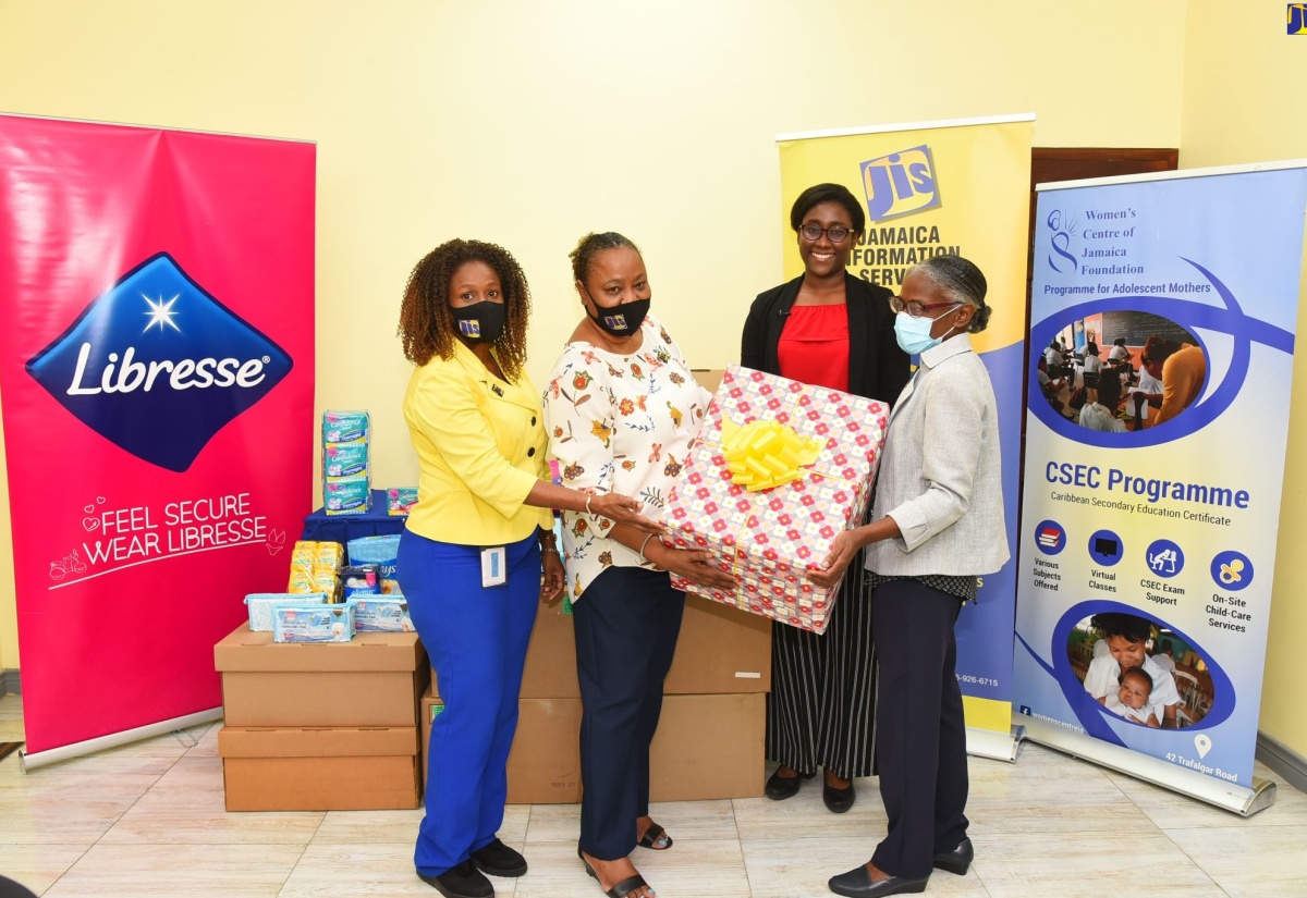 Public Relations and Marketing Manager at the Jamaica Information Service (JIS), Andrea Braham ( left), is joined by team members Joan Gayle (left) and Twila Wheelan, in handing over sanitary products to the Executive Director of the Women’s Centre of Jamaica Foundation (WCJF), Dr. Zoe Simpson (right). The presentation was made at the WCJF’s Trafalgar Road offices in Kingston on Wednesday (March 30 