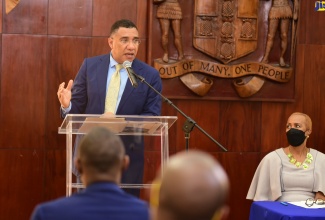 Prime Minister, the Most Hon. Andrew Holness (left), gives the keynote address at the Installation Ceremony for the 2021/23 National Youth Advisory Council of Jamaica. It was held at Jamaica House in Kingston on April 22.  Seated (at right) is Minister of Education and Youth,  Hon. Fayval Williams.

