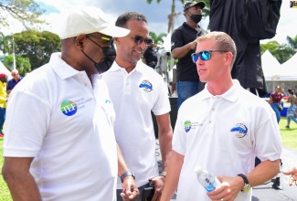 Tourism Minister, Hon. Edmund Bartlett (left), in discussion with Tourism Linkages Network (TLN) Chairman, Adam Stewart (right), during the Blue Mountain Coffee Festival Marketplace at Devon House in Kingston, on Saturday (April 2). The event, hosted by the Tourism Ministry’s Gastronomy Network in collaboration with the Tourism Enhancement Fund (TEF), was staged as part of the thrust to foster the strategic growth of culinary tourism as a product niche for Jamaica. It featured a ‘Wake up with Coffee’ panel discussion, barista and mixology competitions, an artisan village, and live entertainment. Listening is TEF Executive Director, Dr. Carey Wallace.