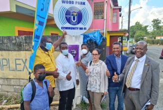 Member of Parliament for St. Mary Western, Robert Montague (third left), and Chief Executive Officer of the Universal Service Fund (USF), Daniel Dawes (right), celebrate the official commissioning into service of a community Wi-Fi hotspot in Woodpark in the constituency, recently. Others pictured (from left) are Donnington Primary School student, Michael Clarke; Councillor for the Gayle Division, Jason James; Councillor for the Carron Hall Division, Doreen Hutchinson; Business Development Manager at the Intercorp Group, Ursula Sanchez Gamarra; and Chief Executive Officer, Ready Communications, Chris Dehring.