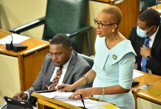 (FILE) Minister of Education and Youth, Hon. Fayval Williams, makes her contribution to the 2022/23 Sectoral Debate in the House of Representatives, on April 12.  At left is Minister without Portfolio in the Office of the Prime Minister with responsibility for Information, Hon. Robert Morgan.