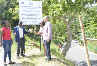 Mayor of Falmouth, Councillor Colin Gager (second left), engages member of the Wilson’s Run Community Development Committee, Kacia Brown (left), following the official handover of Starapple Lane and Common Road in Troy, Trelawny, on Tuesday, May 3. Looking on are Project Manager for the Basic Needs Trust Fund (BNTF), Jamaica Social Investment Fund (JSIF), Dainty Ann Barrett-Smith;  and General Manager for Finance and Procurement at JSIF, Orville Hill. Common Road and Starapple Lane were rehabilitated under a $106-million project implemented by JSIF. 