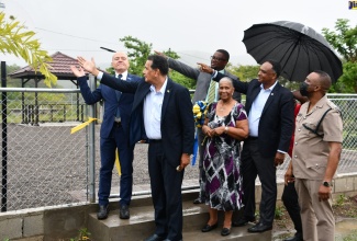 Minister of State in the Office of the Prime Minister, Hon. Homer Davis, (second from left) motions to the newly opened Salt Spring Community Park in St. James, which was handed over by the Jamaica Social Investment Fund (JSIF) to residents on Thursday (May 12). Sharing in the moment are (from left) Head of Cooperation , Delegation of the European Union (EU), Aniceto Rodriguez Ruiz; Member of Parliament for Central St. James, Heroy Clarke; Chairman of the Salt Spring Primary and Infant School Board, Faith Clemmings; Managing Director of JSIF, Omar Sweeney; and Commander of the St. James Police Division – Jamaica Constabulary Force (JCF) , Senior Superintendent of Police (SSP) Vernon Ellis.