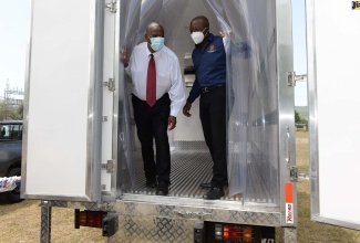 Minister of Agriculture and Fisheries, Hon. Pearnel Charles Jr,. and State Minister, Hon. Franklin Witter, look at the interior of the new refrigerated truck acquired for the Rural Agricultural Development Authority (RADA) St. Elizabeth parish office. Five new vehicles, acquired for the office, were  handed over at the Ministry in Kingston, recently.