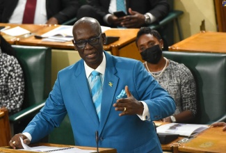 Minister of Local Government and Rural Development, Hon. Desmond McKenzie, makes his 2022/23 Sectoral Debate presentation in the House of Representatives on Wednesday (May 25). Listening is Minister of State, Ministry of Health and Wellness, Hon. Juliet Cuthbert Flynn.