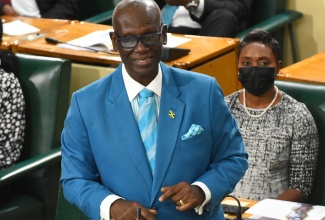 Minister of Local Government and Rural Development, Hon. Desmond McKenzie, makes his contribution to the 2022/23 Sectoral Debate in the House of Representatives, on May 25.  Seated at  right is State Minister in the Ministry of Health and Wellness, Hon. Juliet Cuthbert-Flynn.