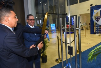 Prime Minister, the Most Hon. Andrew Holness, cuts the ribbon to officially launch Magna Motors Dealership Limited’s (Hyundai) new state-of-the-art facility and seventh anniversary celebrations, at the entity’s Oxford Road address, St. Andrew, on Thursday (May 12). Looking on is Chief Executive Officer (CEO), Magna Motors Dealership (Jamaica), Erick Gutierrez.

 

 