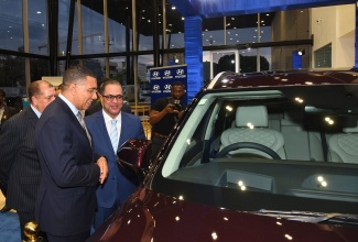 Prime Minister, the Most Hon. Andrew Holness, inspects a new Hyundai motor vehicle while Chief Executive Officer (CEO), Magna Motors Dealership (Jamaica), Erick Gutierrez (right) explains the features. Also looking on is Transport and Mining Minister, Hon. Audley Shaw (partially hidden). The occasion was the official launch of Magna Motors’ (Hyundai) new state-of-the-art facility and seventh anniversary celebrations on Thursday (May 12), at the entity’s Oxford Road address, St. Andrew.

