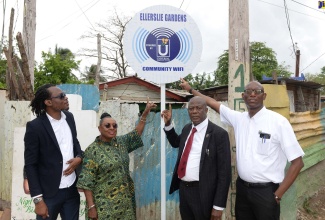 Minister of Culture, Gender, Entertainment and Sport and Member of Parliament for St. Catherine Central, Hon. Olivia Grange (second left) along with (from left) Councillor Caretaker, Spanish Town Division, Christopher Shackleford, Chief Executive Officer, Universal Service Fund (USF), Daniel Dawes and Project Manager, USF, Jaime Robinson, unveil the Ellerslie Gardens Community Wi-Fi sign during a ceremony held in the area on May 13.

 