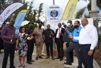 St Elizabeth South West Member of Parliament, Hon. Floyd Green (centre), joins Chief Executive Officer of the Universal Service Fund, Daniel Dawes (fourth right) and Account Manager at Flow, Nigel Burke (right), in celebrating the launch of the Black River Free Public Wi-Fi hotspot. Sharing the moment are (from left) Councillor for the Black River Division, Dwight Salmon; Councillor of the Brompton Division, Whitney Smith-Currie; Superintendent of the Jamaica Fire Brigade, Horace Thomas; Superintendent in the Jamaica Constabulary Force, Dwight Daley; representative of the Custos of St Elizabeth, Godfrey Watson, and Mayor of Black River, Derrick Sangster.

