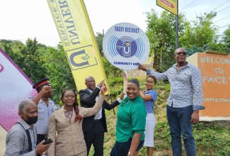 Chief Executive Officer of the Universal Service Fund (USF) Daniel Dawes (fourth left), and Member of Parliament for St. Catherine North Eastern Kerensia Morrison (third right), celebrate the recent commissioning of a free secured wi-fi hotspot, in the deep rural community of Facey, in St. Catherine. Others pictured from left are; Vice President of the Community Development Committee (CDC), Alex Walker; Constable Troy Christian; teacher at the Troja Primary and Infant School, Paula Duncan Frater; Administrative Assistant at Konnexx Services, Jodian Gokhul; and Community Liaison, Robert Grandison. 