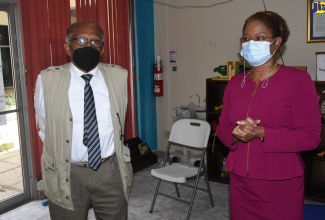 Chairman of the Jamaica Education Transformation Commission (JETC) report, Professor Orlando Patterson (left), enters the offices of the Early Childhood Commission (ECC),  downtown Kingston, on Monday (June 6). Pictured at right is Executive Director of the agency, Karlene DeGrasse-Deslandes.  