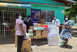 Members of the St. Andrew Technical High School Key Club, hand over packages to the Strathmore Gardens Children's Home, in Spanish Town, St. Catherine recently.  From left are Manager of the Strathmore Gardens Children's Home, Marcia Tucker; Treasurer of the club, Monique Holding; Secretary, Rohanna Carnegie; club member, Kumarco Green; President, Adrian DaCosta, and Faculty Advisor, Shuddey Leachman.

