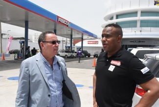 Minister of Science, Energy and Technology, Hon. Daryl Vaz (right), is in conversation with Chief Executive Officer of Future Energy Source Company (FESCO), at the launch of Road Safety Month at the FESCO Service Station on Beechwood Avenue, St. Andrew,  on Wednesday (June 8).