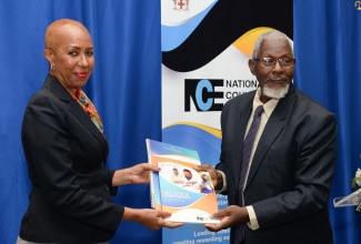 
Minister of Education and Youth, Hon.  Fayval Williams (left), accepts a copy of the National Education Sector Plan from Council Member, National Council on Education (NCE), Professor Disraeli Hutton. Occasion was the final sitting of the current NCE, at the Jamaica Pegasus Hotel in New Kingston on Wednesday (June 29). 
