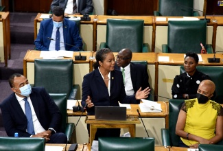 Minister of Legal and Constitutional Affairs, Hon. Marlene Malahoo Forte (centre), making her contribution to the 2022/23 Sectoral Debate in the House of Representatives on Tuesday (June 7). Listening (from left) are Minister of Health and Wellness, Dr. the Hon. Christopher Tufton and Minister of Education and Youth, Hon. Fayval Williams.

