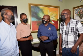 Minister of Agriculture and Fisheries, Hon. Pearnel Charles Jr., engages with (from left) Vice President of the Jamaica Cocoa Farmers Association, Desmond Jadusingh; President of the Jamaica Network of Rural Woman Producers, Tamisha Lee; and President of the Jamaica Coffee Growers Association, Donald Salmon. Occasion was the opening of the ‘Strengthening the Capacity of Farmers’ Organizations to Promote Sustainable Family Farming’ national stakeholder workshop, at the Courtleigh Hotel and Suites in New Kingston on Wednesday (June 1).