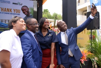 Minister of Agriculture and Fisheries, Hon. Pearnel Charles Jr. (right), takes a selfie with, from left, Representative from Everything Grand Ideas, Nikolette Williams; Managing Director, Development Bank of Jamaica (DBJ), M. Anthony Shaw; and Marketing Manager, DBJ, Trisann Crosbie. Occasion was during the launch of the DBJ’s  ‘AgriBiz’ facility  at the Ministry’s Hope Gardens Complex in Kingston on Tuesday (July 19).