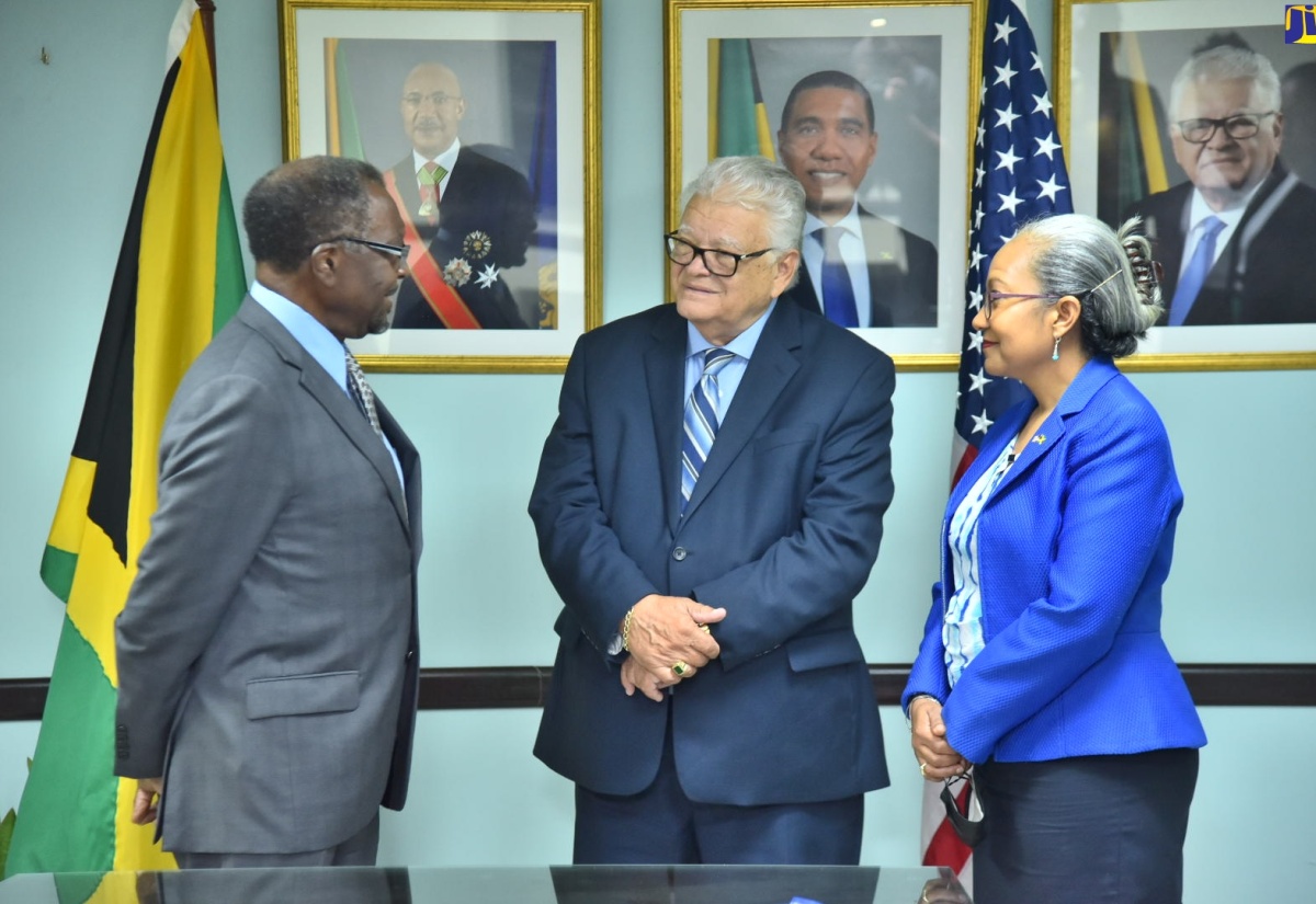 Minister of Labour and Social Security, Hon. Karl Samuda (centre), in discussion with United States (US) Ambassador to Jamaica, His Excellency Nick Perry, during the diplomat’s courtesy call at the Ministry’s offices on North Street in Kingston, on Thursday (July 28). Listening is Permanent Secretary in the Ministry, Colette Roberts Risden. Ambassador Perry also visited the Ministry’s Overseas Employment Centre on East Street in downtown Kingston. 