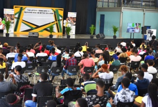 Youth in state care listen as Chief Executive Officer of the Child Protection and Family Agency (CPFSA) Rosalee Gage-Grey, speaks about the Transitional Living Programme (TLP) during the expo held at Jamaica College in St. Andrew on Thursday (July 21).  