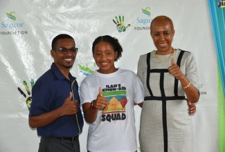 Minister of Education and Youth, Hon. Fayval Williams (right), pauses for a photo with ILAH’s Lemon-Aid Stand For Kids Foundation Founder, Imani-Leigh Hall (centre) and Sagicor Bank Manchester, Branch Manager, Kavon Walker, during a visit to the Foundation’s summer camp at Manchester High School, on Friday (July 22). A donation of $3.5 million from Sagicor has helped the Foundation to stage a three-week literacy and numeracy programme, benefitting over 100 students.