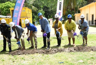 Minister of State in the Office of the Prime Minister, Hon. Homer Davis (centre) breaks ground for the rehabilitation of a sanitation block at the Lethe Primary and Infant School in St. James on June 30. Joining him (from left) are Superintendent of Police in Charge of Operations, St. James Police Division, Eron Samuels; Principal of Bickersteth Primary and Infant School in St. James, Robert Gordon; Owner of Odel Allen Construction, Odel Allen; Senior Manager for Social Development at the Jamaica Social Investment Fund (JSIF), Mona Sue Ho; Regional Director at the Ministry of Education and Youth – Region Four, Dr. Michelle Pinnock; and Principal of Lethe Primary and Infant School, Allison McGhie. 

