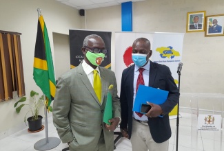 Minister of Local Government and Rural Development, Hon. Desmond McKenzie (left), in discussion with National Solid Waste Management Authority (NSWMA) Executive Director, Audley Gordon.