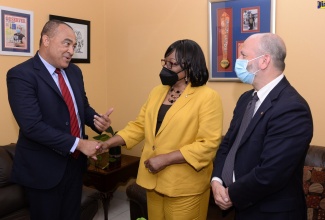 Minister of Health and Wellness, Dr. the Hon. Christopher Tufton, greets Pan American Health Organization (PAHO) Director, Dr. Carissa F. Etienne, on her arrival at the Ministry’s New Kingston office on Wednesday (July 27) for a courtesy call. Dr. Tufton is hosting Dr. Etienne in a series of engagements throughout her four-day visit to Jamaica, from July 26 to 29. At right is PAHO/World Health Organization (WHO) Representative for Jamaica, Bermuda and the Cayman Islands, Ian Stein.  