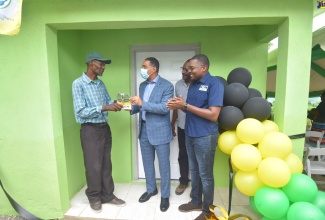 Prime Minister, the Most Hon. Andrew Holness (second left), presents Albert Logan (left), with the keys to his new one-bedroom home during a hand over ceremony at Trout Hall Pass in the Clarendon North Central constituency on Wednesday (July 20). Also participating (from right) are Member of Parliament (MP) for Clarendon North Central and Minister without Portfolio in the Office of the Prime Minister with Responsibility for Information, Hon. Robert Morgan; and Councillor for the Chapelton Division in Clarendon,  Hershel Brown. The house was provided under the Government’s New Social Housing Programme (NSHP) which was developed to improve the housing condition of the country’s poor and disadvantaged population by providing quality, affordable and sustainable housing.  