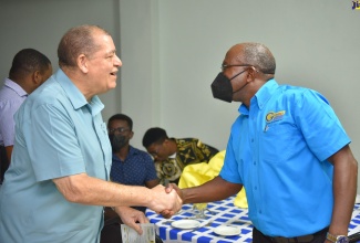 Minister of Transport and Mining, Hon. Audley Shaw (left), greets Managing Director of Grennell’s Driving School, Alphonso Grennell, during the Public Transport Defensive Driving Seminar held on July 27 at the Golf View Hotel, Manchester.