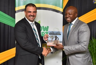 Minister of Agriculture and Fisheries, Hon. Pearnel Charles Jr. (right), presents Bahamian Minister of Agriculture, Marine Resources and Family Island Affairs, Hon. Clay Sweeting, with a token during a courtesy call at the Ministry’s offices in Kingston, on Tuesday (July 26).