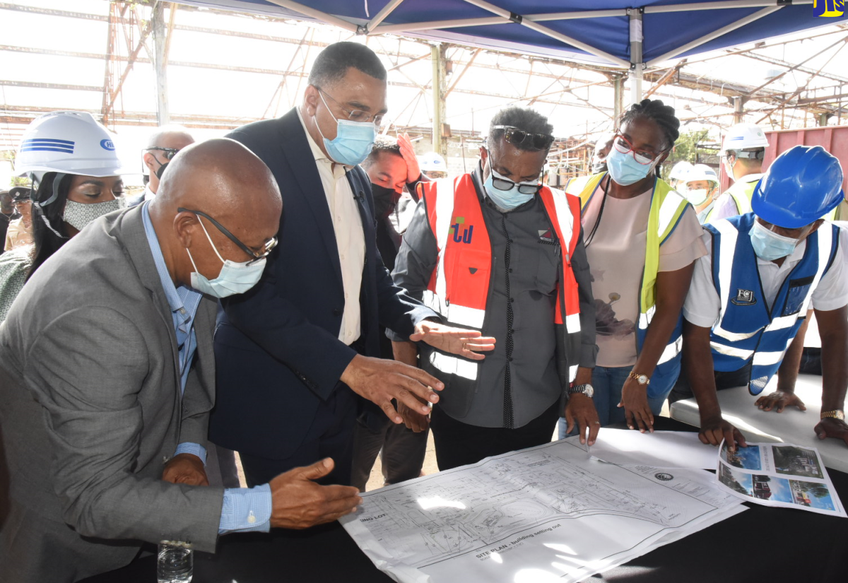 Prime Minister, the Most Hon. Andrew Holness (second left) discusses plans for the Morant Bay Urban Centre project with, from left, Mayor of Morant Bay, Councillor Michael Hue; Architect, Bryan Morris; Kencasa Project Management group representative, Claire-Ann Kennedy; and Chairman of the Factories Corporation of Jamaica (FCJ), Lyttleton Shirley. The Prime Minister toured the site on Thursday (July 14) where he observed preparation work underway on the project.