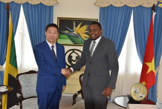 Minister without Portfolio in the Office of the Prime Minister with responsibility for Information, Hon. Robert Morgan (right), shakes hands with Ambassador of the People’s Republic of China to Jamaica, His Excellency Chen Daojiang, during a courtesy call at Jamaica House on Wednesday (August 3).

