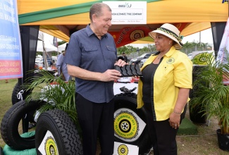 Minister of Transport and Mining, Hon. Audley Shaw, is being shown a piece of tyre by Sales and Marketing Officer at Jamaica Ultimate Tyre Company, Beverly Solomon. Occasion was the Ministry’s Jamaica 60 Expo at the Police Officers Club in St. Andrew on Friday (July 29), under the theme ‘The Embers of Evolution…Fuel for the Future’. 