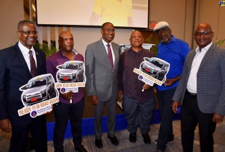 Minister of Finance and the Public Service, Dr. the Hon. Nigel Clarke (third left), with stakeholders attending the recent launch of the Development Bank of Jamaica’s (DBJ) Entertainment and Transport Sector Loans, at the AC Marriott Kingston Hotel. From left are Manager, Investor Relationships, DBJ, Paul Chin; Co-owner and General Manager, City Guide Taxi Service, Daniel Whyte; Owner/Operator, Blue Diamond Taxicab Company Limited, Milton Chung; President, All Island United Route Taxi Association, Raymond Bynes; and Product and Sales Development Manager, LASCO Microfinance Limited, Richard Benjamin.

