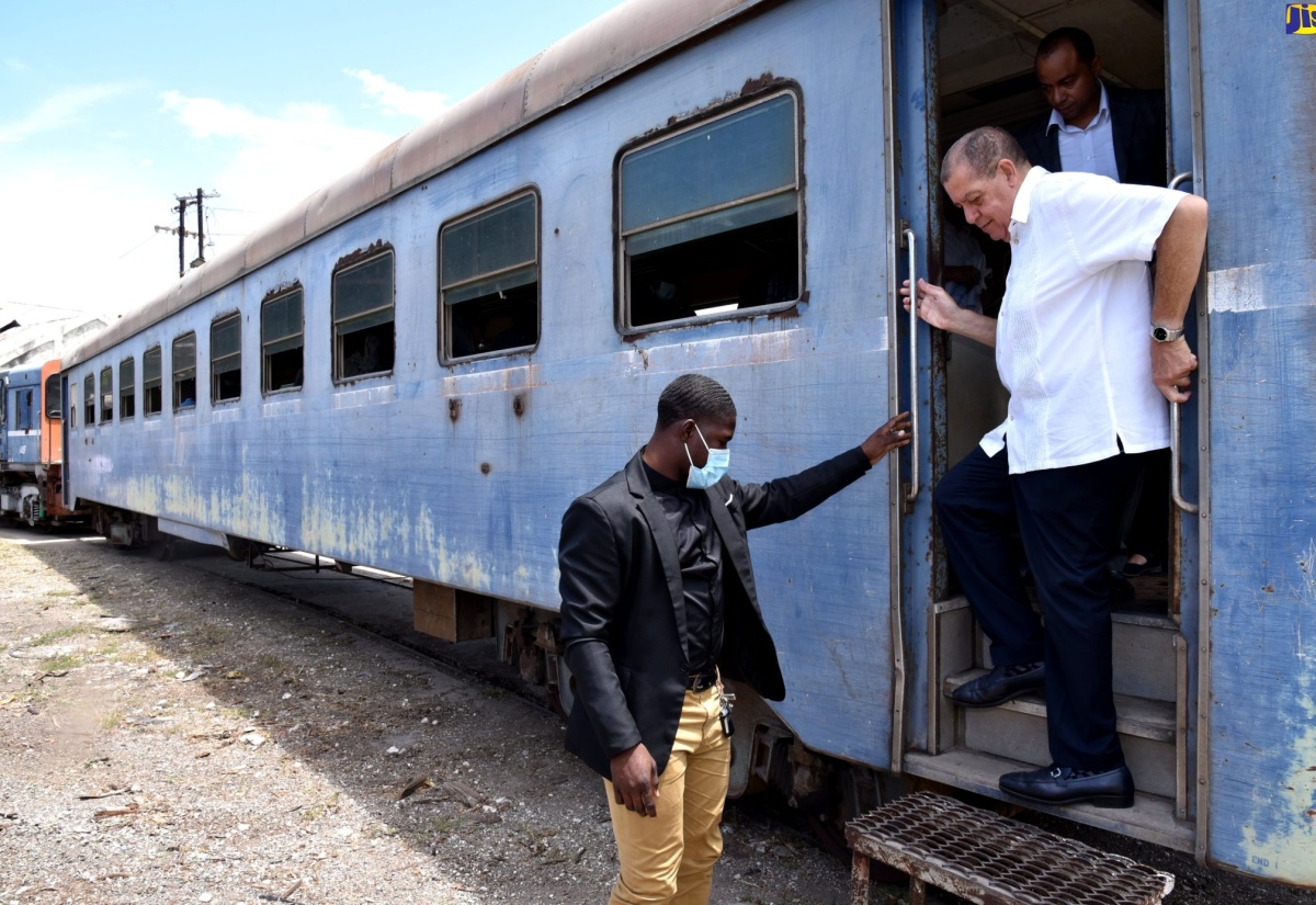 Minister of Transport and Mining, Hon. Audley Shaw (centre), disembarks a train during a recent tour of the Jamaica Railway Corporation (JRC) terminus in West Kingston. 
                                                                                                                               
