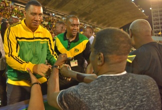 Prime Minister, the Most Hon. Andrew Holness (left), greets members of the public, during the Jamaica 60 Independence Grand Gala at the National Stadium in Kingston on August 6. 



