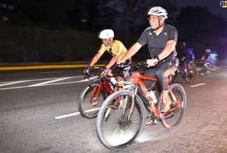Prime Minister, the Most Hon. Andrew Holness (right), rides alongside Dennis Chung of Discover Jamaica by Bike during the organisation’s ‘Jamaica 60’ celebration ride Saturday (August 13). The event is being used to highlight Jamaica 60 celebrations and share the experience of cycling in Jamaica.  